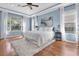 Bright primary bedroom with hardwood floors, tray ceilings, and a large window at 11620 Bristol Chase Dr, Tampa, FL 33626