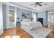 Bright primary bedroom with hardwood floors, tray ceilings, and a large window at 11620 Bristol Chase Dr, Tampa, FL 33626