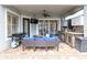 Covered outdoor kitchen, with built-in grill, refrigerator, and comfortable seating at 11620 Bristol Chase Dr, Tampa, FL 33626