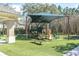 Community playground with a shaded area and bench at 11620 Bristol Chase Dr, Tampa, FL 33626