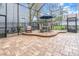 Screened patio features a dining area and cozy seating for outdoor entertainment at 11620 Bristol Chase Dr, Tampa, FL 33626