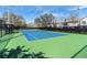 A community tennis court surrounded by green landscaping at 11620 Bristol Chase Dr, Tampa, FL 33626