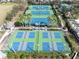 Aerial view of the community tennis and pickleball courts, surrounded by mature landscaping and trees at 11620 Bristol Chase Dr, Tampa, FL 33626