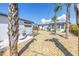 Backyard view featuring palm trees and a detached garage at 14066 Marguerite Dr, Madeira Beach, FL 33708
