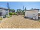 Backyard showcasing the detached garage, privacy fence, and landscaping at 14066 Marguerite Dr, Madeira Beach, FL 33708