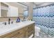 Bathroom showcasing double sinks, stylish fixtures, and patterned tile flooring at 14066 Marguerite Dr, Madeira Beach, FL 33708