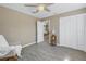 Neutral bedroom features a ceiling fan and direct access to an adjacent living space at 14066 Marguerite Dr, Madeira Beach, FL 33708