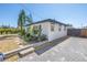 Exterior home view showcasing paver driveway, tropical landscaping, and a private fenced yard at 14066 Marguerite Dr, Madeira Beach, FL 33708