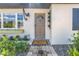 Inviting front entrance features a stylish door, charming decor, and a well-manicured landscape at 14066 Marguerite Dr, Madeira Beach, FL 33708