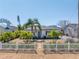 Inviting home with white picket fence, tropical landscaping, decorative rock, and stone walkway at 14066 Marguerite Dr, Madeira Beach, FL 33708