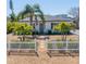 Charming single-story home with well-maintained landscaping, gravel yard, picket fence and walkway leading to the front door at 14066 Marguerite Dr, Madeira Beach, FL 33708