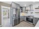 Modern kitchen with stainless steel appliances and gray cabinets at 14066 Marguerite Dr, Madeira Beach, FL 33708
