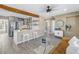 Open-concept living space with kitchen island and stylish gray cabinets at 14066 Marguerite Dr, Madeira Beach, FL 33708