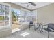 Enclosed patio featuring tiled floors, a ceiling fan, and view to the landscaped backyard at 14066 Marguerite Dr, Madeira Beach, FL 33708