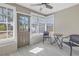 Bright sun room with tile floors and relaxing seating area at 14066 Marguerite Dr, Madeira Beach, FL 33708