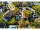 An aerial view of a home with a screened-in pool surrounded by a lush green lawn and mature trees at 15107 Laurel Cove Cir, Odessa, FL 33556