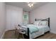 Cozy bedroom showcasing wood floors, a ceiling fan, and a whimsical alligator bench at 15107 Laurel Cove Cir, Odessa, FL 33556