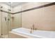 Elegant bathroom featuring a soaking tub and a glass-enclosed shower with tiled walls at 175 1St S St # 1104, St Petersburg, FL 33701