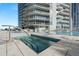 Inviting hot tub with city views and lounge chairs, perfect for unwinding and enjoying luxury amenities at 175 1St S St # 1104, St Petersburg, FL 33701