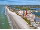 Aerial view of beachfront condo property with pool and stunning water views on a sunny day at 17920 Gulf Blvd # 702, Redington Shores, FL 33708