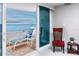 Relaxing balcony with lounge chair and table offering stunning views of the ocean at 17920 Gulf Blvd # 702, Redington Shores, FL 33708