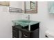 Elegant bathroom with a stylish glass vessel sink atop a dark vanity with lots of storage at 17920 Gulf Blvd # 702, Redington Shores, FL 33708