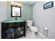 Stylish half bathroom featuring a modern vanity, mosaic tile accent wall and modern toilet at 17920 Gulf Blvd # 702, Redington Shores, FL 33708