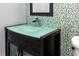 Close up on modern bathroom with a stylish vanity, mosaic tile wall and modern faucet at 17920 Gulf Blvd # 702, Redington Shores, FL 33708