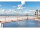 Beachfront community pool offers recreation with ocean views in a landscaped setting at 17920 Gulf Blvd # 702, Redington Shores, FL 33708