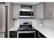 Well-equipped kitchen with stainless steel appliances and sleek countertops for modern cooking at 17920 Gulf Blvd # 702, Redington Shores, FL 33708