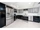 Modern kitchen boasts stainless steel appliances, two-tone cabinetry and updated lighting at 17920 Gulf Blvd # 702, Redington Shores, FL 33708