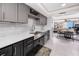 Bright kitchen with stainless steel appliances, light countertops, and a view to the dining area at 17920 Gulf Blvd # 702, Redington Shores, FL 33708