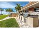 Outdoor kitchen area with stainless steel grills steps from beach access and ocean views at 17920 Gulf Blvd # 702, Redington Shores, FL 33708