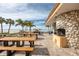 Charming outdoor seating area and grilling area overlooking ocean and community landscaping at 17920 Gulf Blvd # 702, Redington Shores, FL 33708