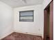 Bedroom with a window with blinds, light walls, and brown carpet at 18108 Crooked Ln, Lutz, FL 33548