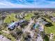 Aerial view of community amenities, including a clubhouse, pool, and tennis and pickleball courts at 18504 Water Lily Ln, Hudson, FL 34667