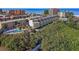 Aerial view of condo building, showcasing beach access, and nestled amid lush foliage at 19727 Gulf Blvd # 209, Indian Shores, FL 33785