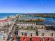 Stunning aerial view of beachfront condos and waterway with clear blue skies and sandy beaches in a coastal neighborhood at 19727 Gulf Blvd # 209, Indian Shores, FL 33785