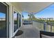 Inviting balcony featuring a hanging swing, offering a relaxing outdoor space with views of the surrounding neighborhood at 19727 Gulf Blvd # 209, Indian Shores, FL 33785