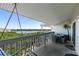 Enjoy the covered balcony with a swing and comfortable outdoor furniture overlooking the calm water at 19727 Gulf Blvd # 209, Indian Shores, FL 33785