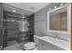 Contemporary bathroom featuring a glass-enclosed shower with tiled walls, a modern sink vanity, and sleek fixtures at 19727 Gulf Blvd # 209, Indian Shores, FL 33785