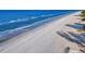 Expansive beach with gentle waves and bright blue water under clear blue skies at 19727 Gulf Blvd # 209, Indian Shores, FL 33785