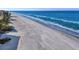 Beautiful wide beach with soft sand and calm ocean water, perfect for relaxation and coastal activities at 19727 Gulf Blvd # 209, Indian Shores, FL 33785