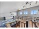 Spacious loft bedroom with hardwood floors, natural light from multiple windows, and a ceiling fan at 19727 Gulf Blvd # 209, Indian Shores, FL 33785