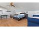 Comfortable bedroom featuring hardwood floors, a ceiling fan, and an inviting bed at 19727 Gulf Blvd # 209, Indian Shores, FL 33785