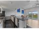 Open-concept kitchen with stainless steel appliances, granite countertops, and a seamless flow to the balcony at 19727 Gulf Blvd # 209, Indian Shores, FL 33785