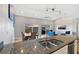 Open-concept living space featuring granite counters, modern appliances, and waterviews at 19727 Gulf Blvd # 209, Indian Shores, FL 33785
