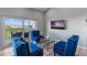 Inviting living room featuring comfortable seating, a TV, and a sliding glass door to the balcony at 19727 Gulf Blvd # 209, Indian Shores, FL 33785