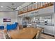 Bright and airy living space with spiral staircase and 'Beach' signage, combining kitchen and dining at 19727 Gulf Blvd # 209, Indian Shores, FL 33785