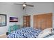 Relaxing main bedroom featuring a ceiling fan, a TV, ample closet space, and stylish decor for comfortable living at 19727 Gulf Blvd # 209, Indian Shores, FL 33785